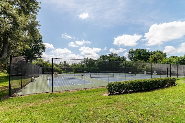 view of sport court featuring a lawn