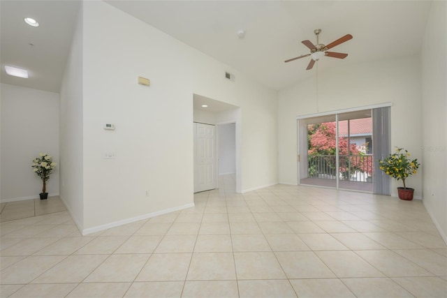 spare room with ceiling fan, light tile patterned floors, and high vaulted ceiling