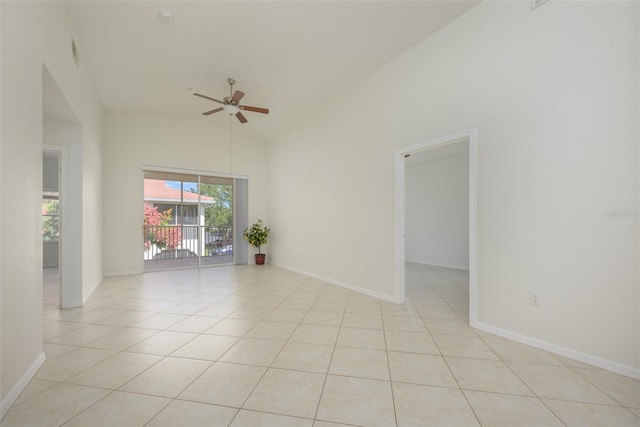 empty room with high vaulted ceiling, ceiling fan, and light tile patterned flooring