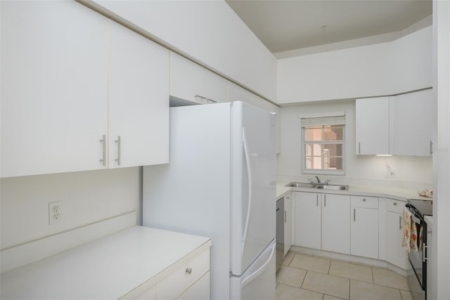 kitchen featuring white cabinets, white appliances, sink, and light tile patterned floors