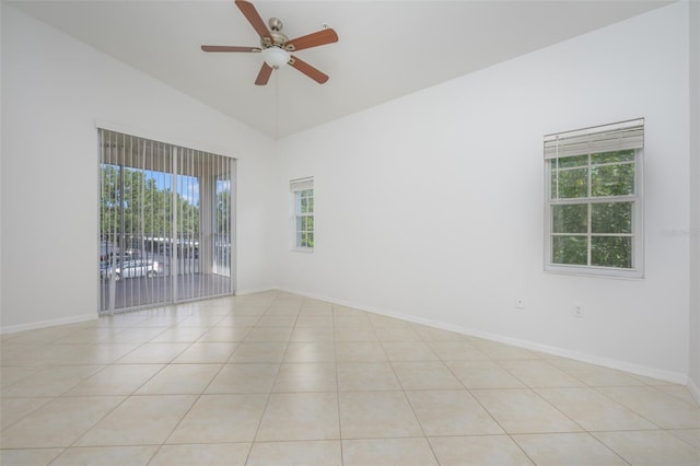 tiled spare room with a healthy amount of sunlight, ceiling fan, and lofted ceiling