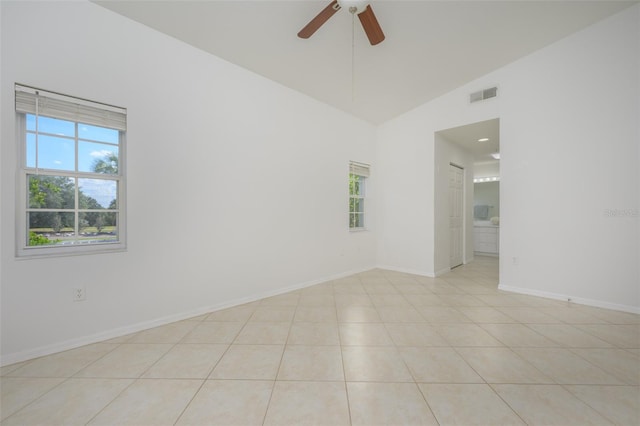 unfurnished room featuring vaulted ceiling, ceiling fan, and light tile patterned flooring