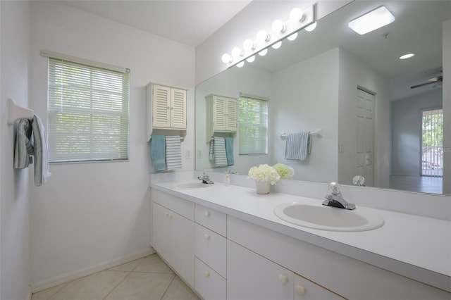 bathroom with tile patterned flooring, vanity, ceiling fan, and a wealth of natural light