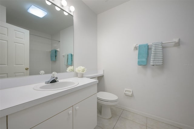 bathroom featuring tile patterned floors, vanity, toilet, and tiled shower