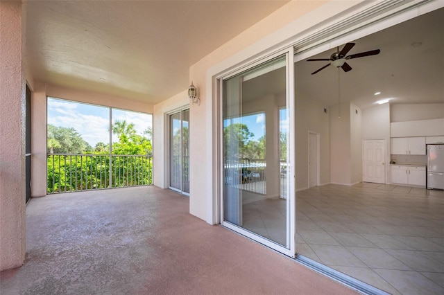 unfurnished sunroom with ceiling fan and lofted ceiling