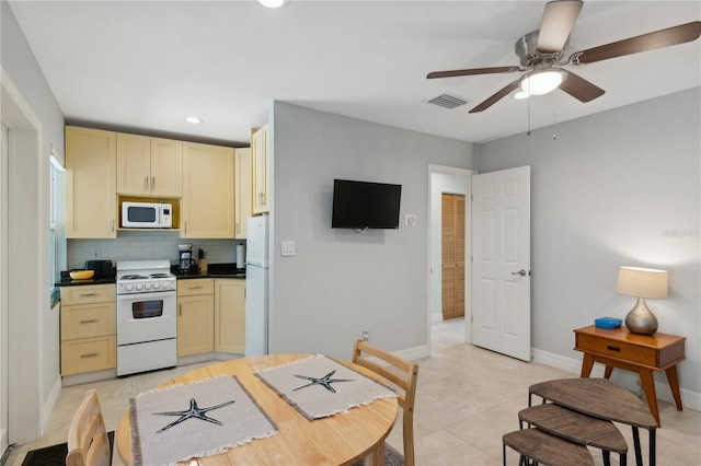 kitchen featuring light tile patterned floors, white appliances, ceiling fan, and backsplash