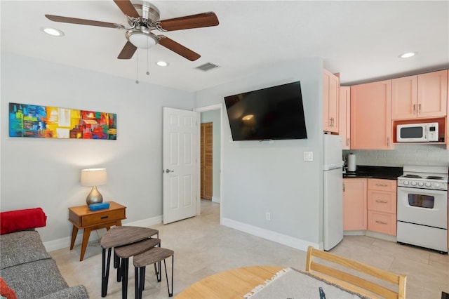 kitchen featuring backsplash, ceiling fan, light brown cabinets, and white appliances