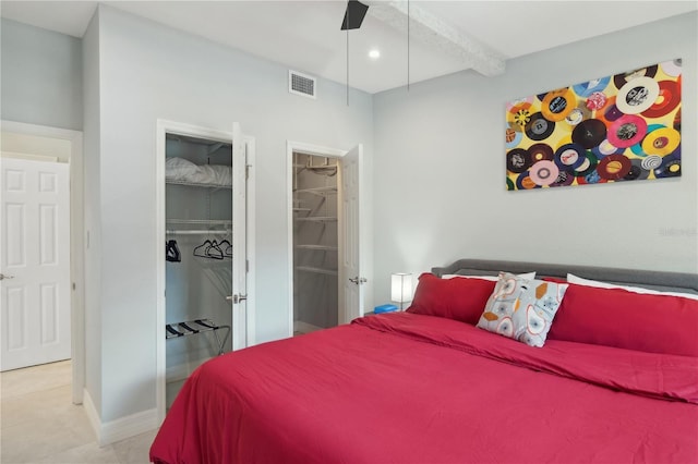 bedroom with beam ceiling, a spacious closet, and a closet