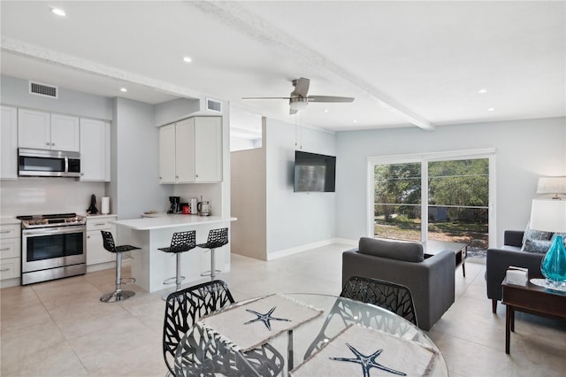 living room with beamed ceiling and ceiling fan