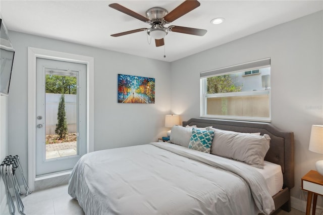 tiled bedroom with multiple windows, ceiling fan, and access to exterior