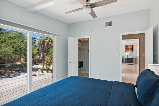 bedroom with access to outside, ceiling fan, a closet, and a spacious closet