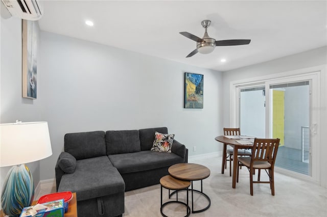 living room with an AC wall unit and ceiling fan