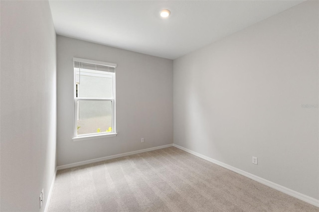 unfurnished room with light carpet