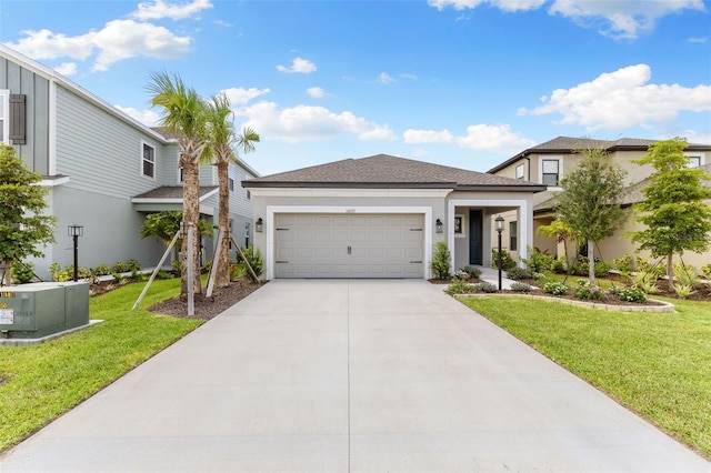 view of front facade with a garage and a front lawn