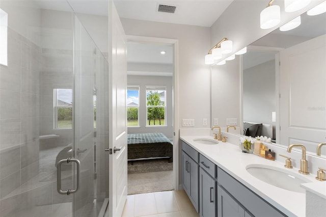 bathroom with tile patterned flooring, vanity, and a shower with shower door