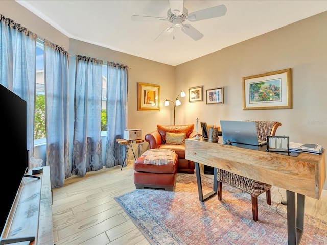 office area featuring ceiling fan, a healthy amount of sunlight, and light hardwood / wood-style flooring