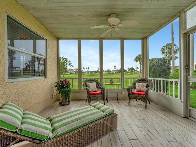 sunroom / solarium featuring ceiling fan