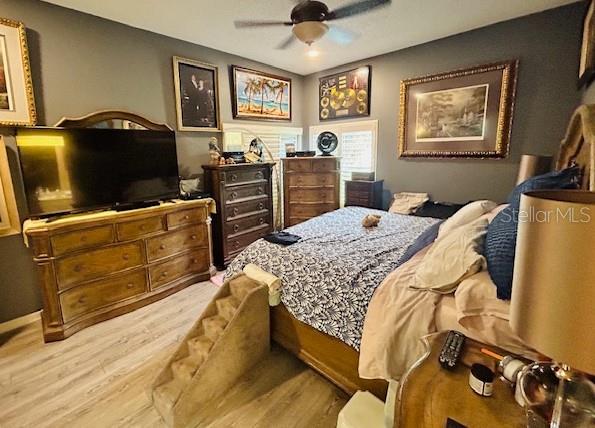 bedroom with a ceiling fan and wood finished floors