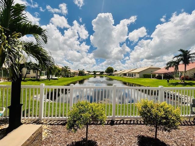 exterior space with a water view, a residential view, and fence