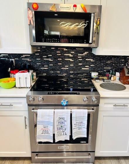 kitchen featuring light countertops, appliances with stainless steel finishes, and white cabinets