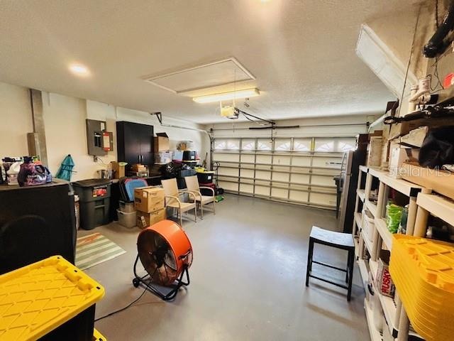 garage with a garage door opener and electric panel