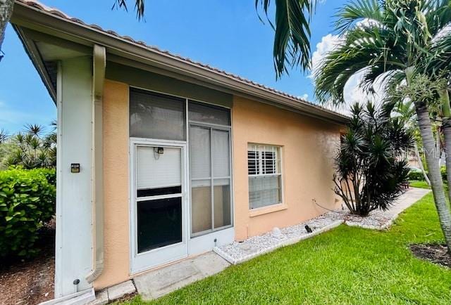 view of side of home with a yard