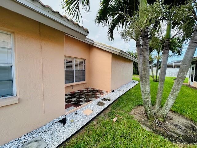 view of home's exterior with a lawn and stucco siding