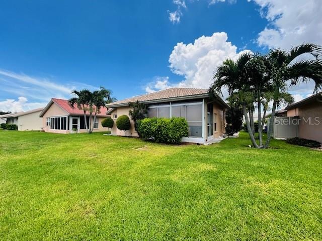 rear view of property with a lawn