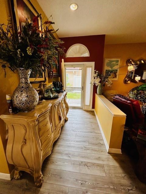 foyer with light wood-type flooring and baseboards