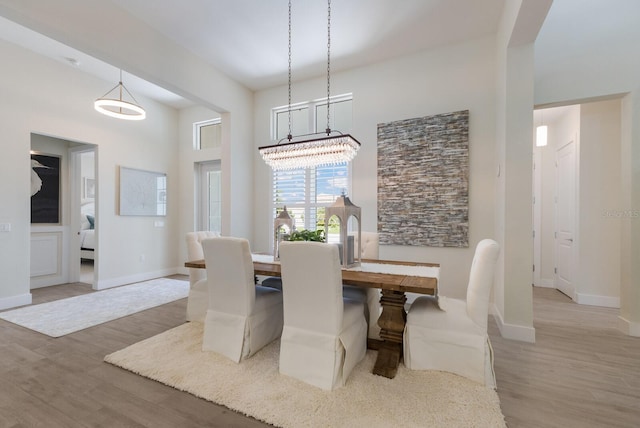 dining room with a chandelier and wood-type flooring