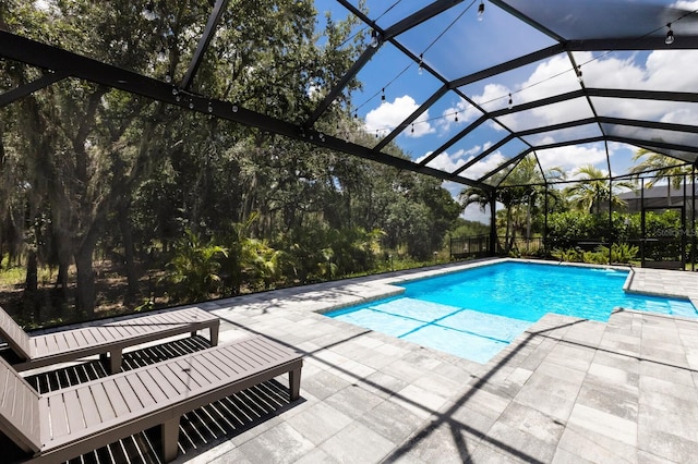 view of pool featuring a lanai and a patio