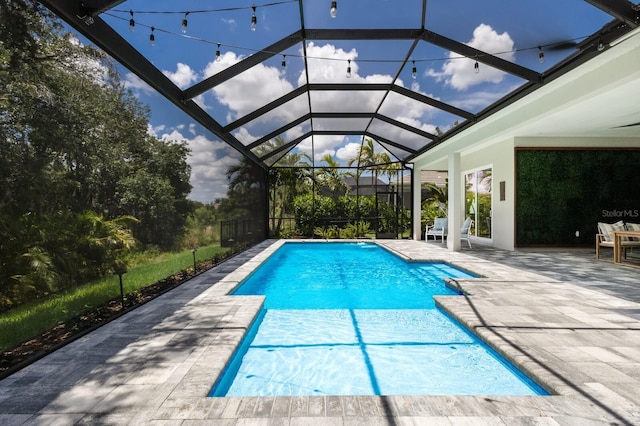 view of pool with a lanai and a patio