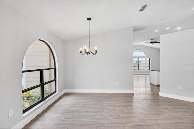 spare room featuring lofted ceiling, baseboards, visible vents, and wood tiled floor