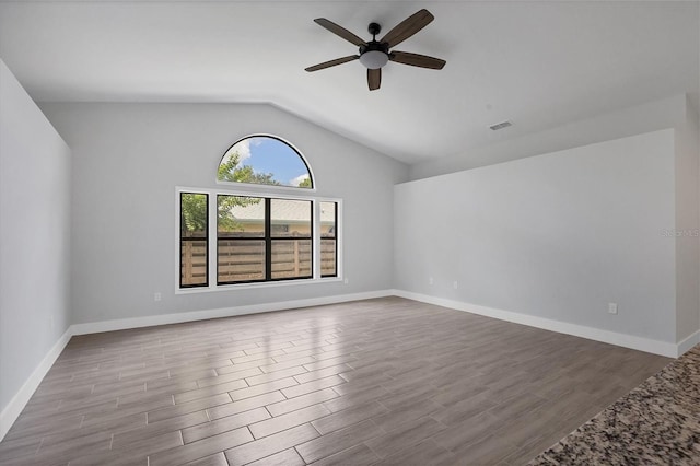 empty room with light wood-type flooring, visible vents, ceiling fan, and lofted ceiling