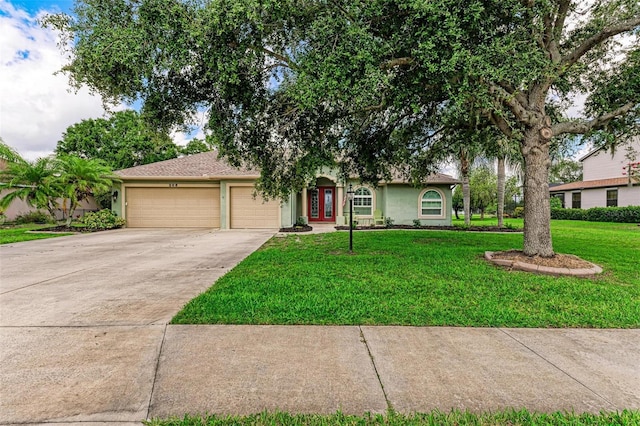 view of front of home with a front yard and a garage