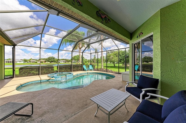 view of swimming pool featuring an in ground hot tub, a patio, and a lanai