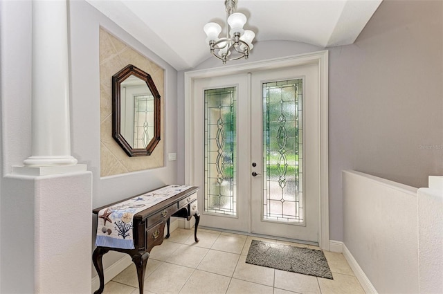 entryway featuring french doors, light tile patterned flooring, lofted ceiling, and a notable chandelier