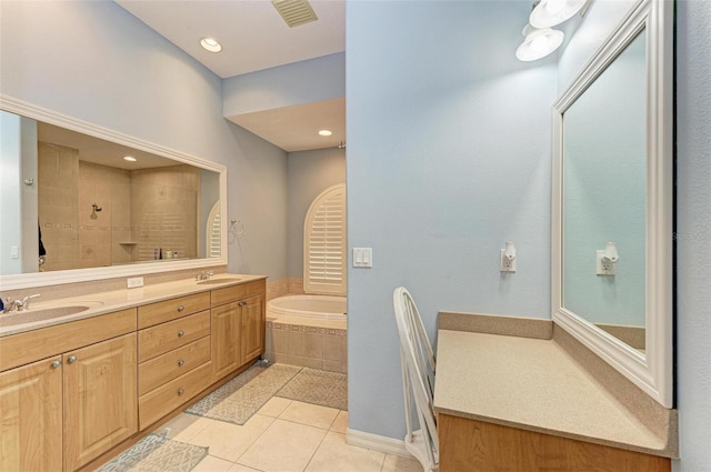 bathroom with tile patterned floors, vanity, and shower with separate bathtub