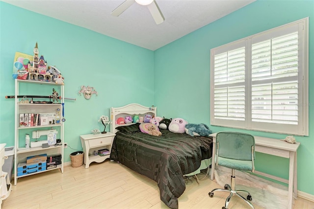 bedroom with ceiling fan and light hardwood / wood-style floors