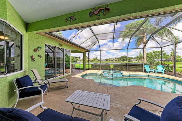 view of pool with a lanai, a patio area, and an in ground hot tub