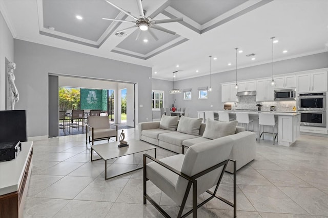 tiled living room featuring ornamental molding, coffered ceiling, ceiling fan, sink, and beamed ceiling