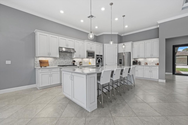 kitchen featuring white cabinetry, a center island with sink, and appliances with stainless steel finishes