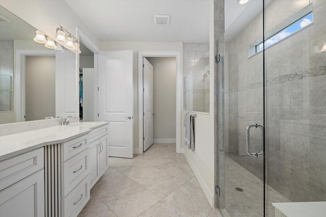 bathroom featuring vanity and a shower with door