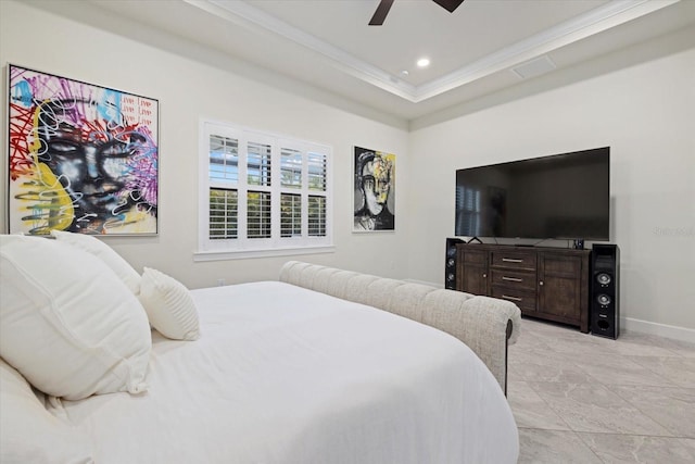 bedroom featuring ceiling fan, ornamental molding, and a tray ceiling