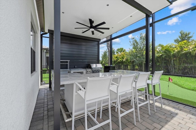 sunroom with ceiling fan