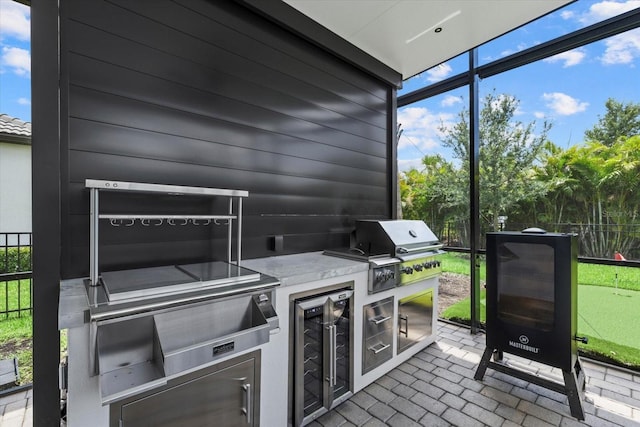 view of patio featuring area for grilling, beverage cooler, and a grill