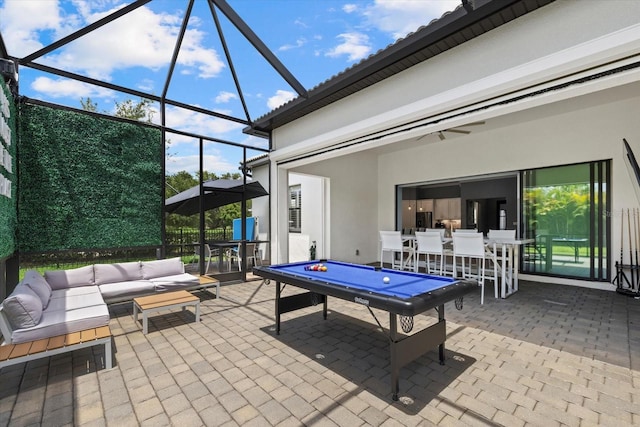 view of patio featuring an outdoor hangout area and glass enclosure