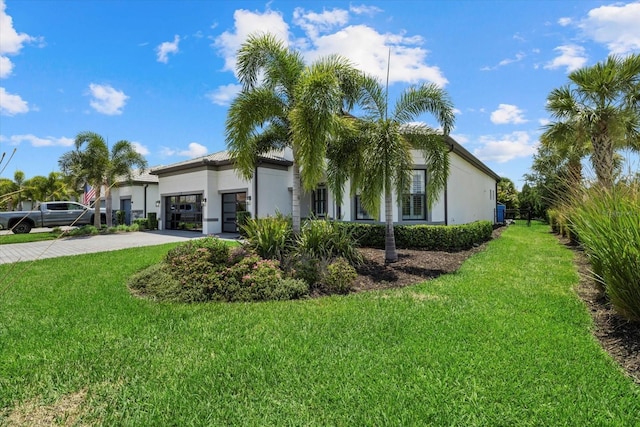 view of side of home featuring a lawn and a garage