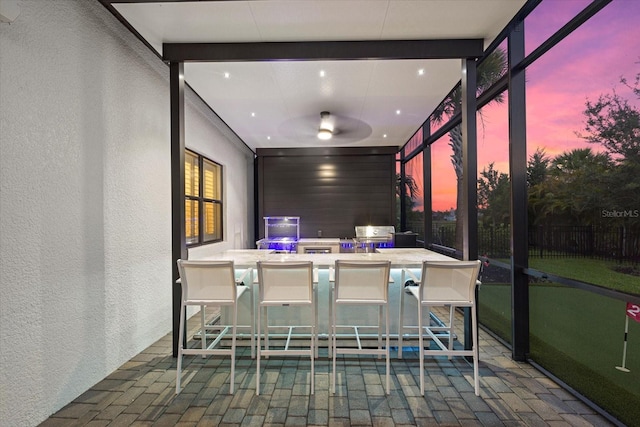 sunroom / solarium featuring ceiling fan