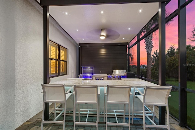 sunroom / solarium featuring ceiling fan